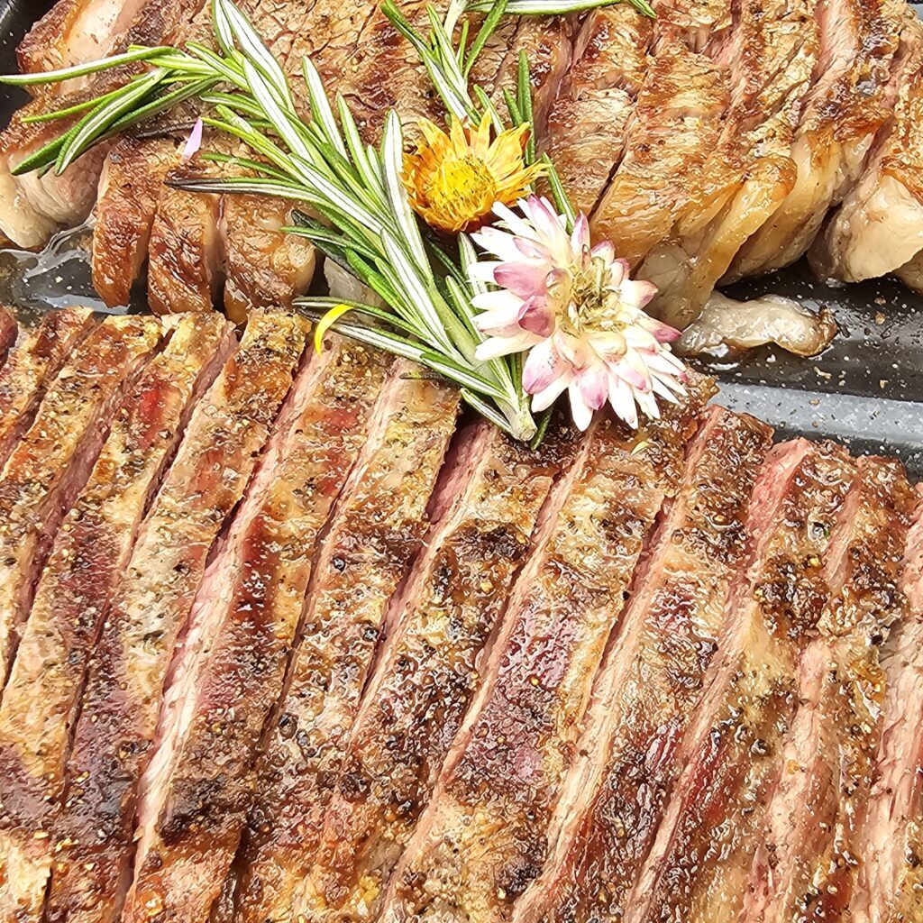 Prime Flank Steak seared over an open-fire grill for a boutique event catering.